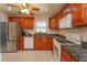 Updated kitchen with granite countertops and wood cabinets at 664 Little Wekiva Rd, Altamonte Springs, FL 32714