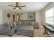 Open living area with comfortable sectional sofa and large windows at 664 Little Wekiva Rd, Altamonte Springs, FL 32714