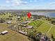 Aerial view showcasing the home and surrounding land near a lake at 6820 County Road 561, Clermont, FL 34714