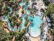 Aerial view of resort pool area, showcasing a relaxing lagoon-style pool and lounge chairs at 7740 Sandy Ridge Dr # 141, Reunion, FL 34747