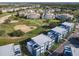 Aerial view of townhouses and golf course at 7740 Sandy Ridge Dr # 141, Reunion, FL 34747