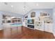 Living room with hardwood floors, fireplace, and pool view at 17429 Cobblestone Ln, Clermont, FL 34711