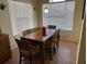 Dining area with a wood table, chairs, and large window at 2202 Key West Ct # 632, Kissimmee, FL 34741