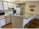 Kitchen with breakfast bar, white cabinets, and appliances at 2202 Key West Ct # 632, Kissimmee, FL 34741