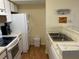 Efficient kitchen features white appliances and wood-look flooring at 2202 Key West Ct # 632, Kissimmee, FL 34741