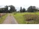 Gravel driveway leading to property with open fields at 3555 E Johnson Ave, Haines City, FL 33844