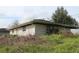 Brick home with overgrown yard at 3555 E Johnson Ave, Haines City, FL 33844
