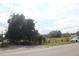 Vacant lot with roadside view and mature trees at 3555 E Johnson Ave, Haines City, FL 33844