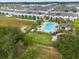 Aerial view of community pool, with surrounding townhomes and playground at 397 Madison Dr, Davenport, FL 33837