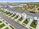 Aerial view of townhouses with gray roofs and green landscaping at 397 Madison Dr, Davenport, FL 33837