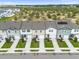 Aerial view of townhouses with gray roofs, green landscaping, and solar panels at 397 Madison Dr, Davenport, FL 33837