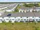 Aerial view of townhomes showcasing back patios and solar panels at 397 Madison Dr, Davenport, FL 33837