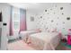 Charming bedroom with twin beds and polka dot wall at 397 Madison Dr, Davenport, FL 33837