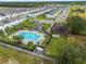 Community pool with playground and gazebo, surrounded by palm trees at 397 Madison Dr, Davenport, FL 33837