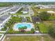 Community pool with playground and gazebo, surrounded by palm trees at 397 Madison Dr, Davenport, FL 33837