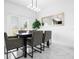 Modern dining area with gray chairs and a dark wood table at 397 Madison Dr, Davenport, FL 33837