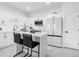 Modern white kitchen with stainless steel appliances and a kitchen island at 397 Madison Dr, Davenport, FL 33837