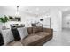 Living room with brown sectional sofa and a modern black feature wall at 397 Madison Dr, Davenport, FL 33837
