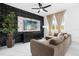 Living room with brown sectional sofa and geometric black accent wall at 397 Madison Dr, Davenport, FL 33837