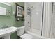 Clean bathroom with subway tile, a shower/tub combo, and a pedestal sink at 423 N Main St, Winter Garden, FL 34787