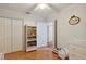 Charming bedroom with hardwood floors, built-in shelves, and ample closet space at 423 N Main St, Winter Garden, FL 34787