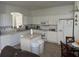 Kitchen with white cabinets, island, and stainless steel appliances at 4704 Delray Beach Ct, Kissimmee, FL 34746