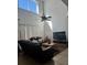 Spacious living room with high ceilings, large windows, and a ceiling fan at 4704 Delray Beach Ct, Kissimmee, FL 34746