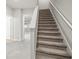 Modern staircase with carpeted steps and neutral wall colors at 5025 Caspian St, Saint Cloud, FL 34771