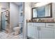 Bathroom with granite countertop, white cabinets, and a walk-in shower at 7270 Westpointe Blvd # 914, Orlando, FL 32835