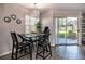 Bright dining area with glass table, modern chairs, and sliding glass doors leading to patio at 7270 Westpointe Blvd # 914, Orlando, FL 32835
