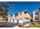 Condo building with attached garages and manicured lawn at 7270 Westpointe Blvd # 914, Orlando, FL 32835