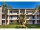 Two-story condo building with balconies and lush landscaping at 7270 Westpointe Blvd # 914, Orlando, FL 32835