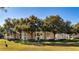 Unit #914, building exterior view, surrounded by lush landscaping at 7270 Westpointe Blvd # 914, Orlando, FL 32835