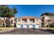 Condo building with garages and a spacious parking area at 7270 Westpointe Blvd # 914, Orlando, FL 32835