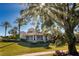 Stunning home exterior with a large covered patio, lush landscaping, and a beautiful tree at 7270 Westpointe Blvd # 914, Orlando, FL 32835