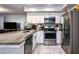 Open concept kitchen with granite countertops and stainless steel appliances at 7270 Westpointe Blvd # 914, Orlando, FL 32835