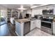 Modern kitchen with white cabinets, granite counters, and stainless steel appliances at 7270 Westpointe Blvd # 914, Orlando, FL 32835