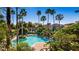 Inviting community pool surrounded by palm trees and lush landscaping at 7270 Westpointe Blvd # 914, Orlando, FL 32835