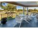 Relaxing porch overlooking a scenic golf course with white Adirondack chairs at 7270 Westpointe Blvd # 914, Orlando, FL 32835