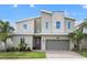 Two-story modern home with stone accents and a two-car garage at 8842 Cabot Cliffs Dr, Davenport, FL 33896