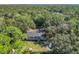 Aerial view showing a home nestled in a lush, wooded setting at 1257 Mullet Lake Park Rd, Geneva, FL 32732