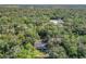 Aerial view of a home nestled in a wooded area, offering privacy and tranquility at 1257 Mullet Lake Park Rd, Geneva, FL 32732