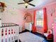 Bedroom with pink walls and rainbow decor at 1257 Mullet Lake Park Rd, Geneva, FL 32732