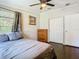 Bedroom with gray bedding and dark hardwood floors at 1257 Mullet Lake Park Rd, Geneva, FL 32732