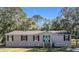 Single story home with gray siding, black shutters, and teal front door at 1257 Mullet Lake Park Rd, Geneva, FL 32732