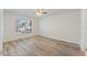 Bright bedroom with wood-look flooring and ceiling fan at 13303 Pinyon Dr, Clermont, FL 34711