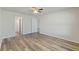 Bedroom with wood-look floors and access to bathroom at 13303 Pinyon Dr, Clermont, FL 34711