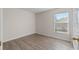 Cozy bedroom with large window and laminate flooring at 13303 Pinyon Dr, Clermont, FL 34711
