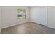 Well-lit bedroom with laminate floors and double door closet at 13303 Pinyon Dr, Clermont, FL 34711