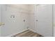 Laundry room with built-in shelving and vinyl flooring at 13303 Pinyon Dr, Clermont, FL 34711
